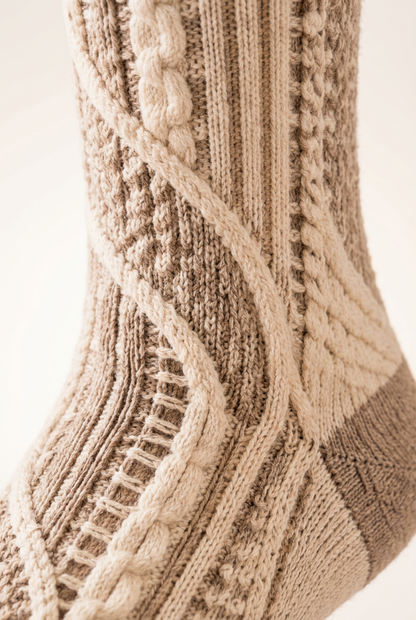 Sweeping ivory cable and ladder knit detail