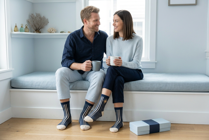 Same couple together by window wearing navy pinstripe socks